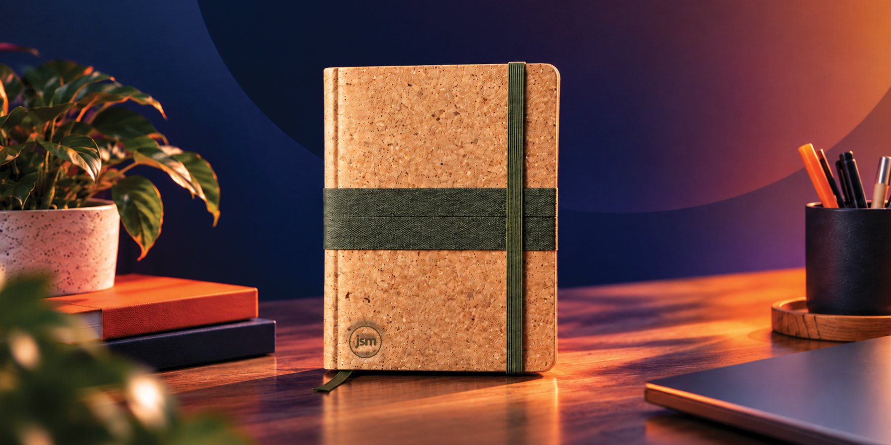 Cork notebook on a desk surrounded by small potted plants