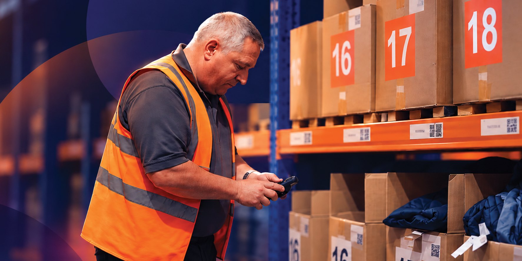 Warehouse team member scanning branded merchandise kits with a handheld scanner