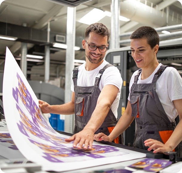 JSM team checking a freshly printed sheet on the in-house printing press