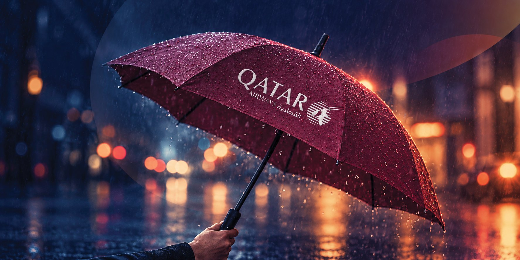 Branded Qatar Airways umbrella being used in the rain